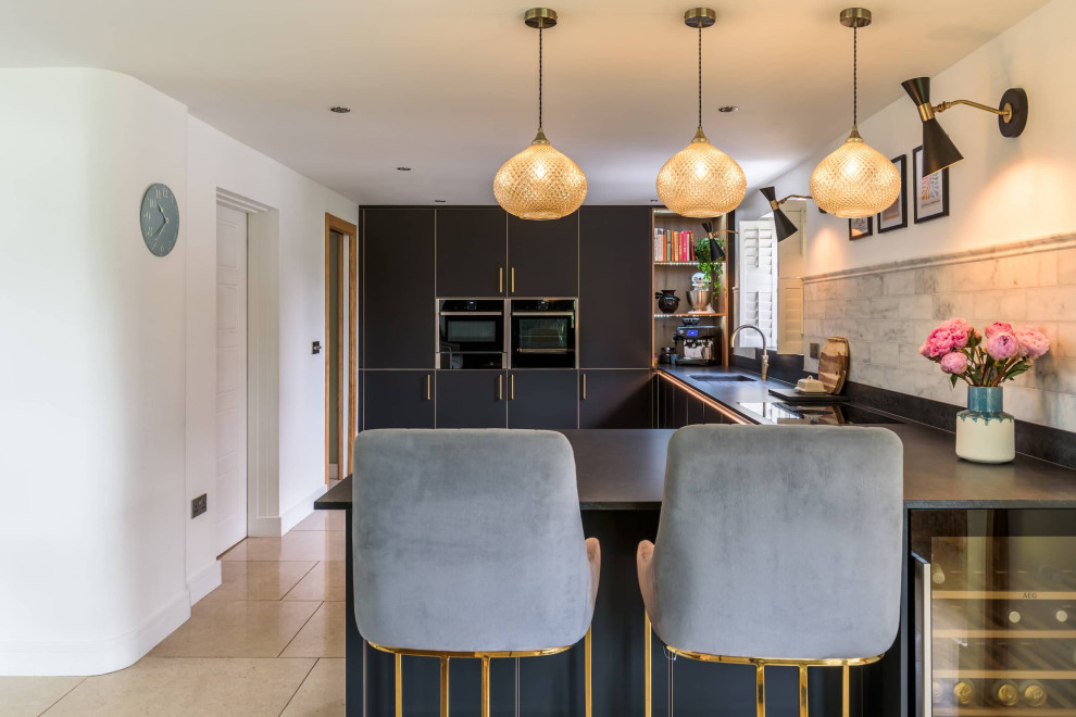 Inspiration for a small contemporary l-shaped open plan kitchen in Sussex with a submerged sink, beaded cabinets, black cabinets, quartz worktops, grey splashback, black appliances, ceramic flooring, an island, brown floors, black worktops and feature lighting.