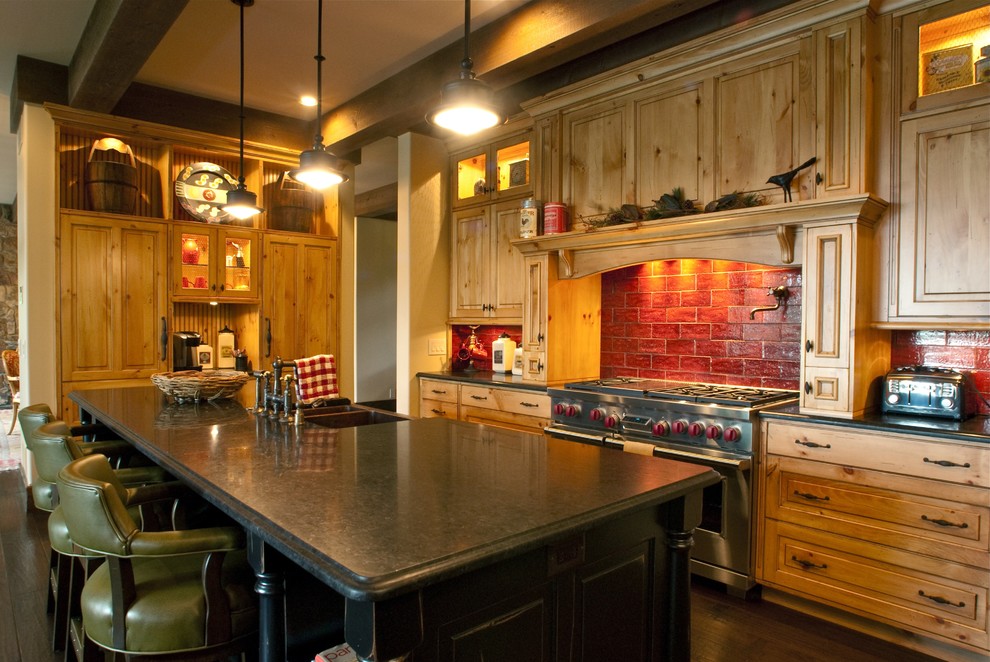 Inspiration for a large eclectic l-shaped dark wood floor open concept kitchen remodel with a farmhouse sink, beaded inset cabinets, light wood cabinets, granite countertops, red backsplash, ceramic backsplash, stainless steel appliances, beige walls and an island