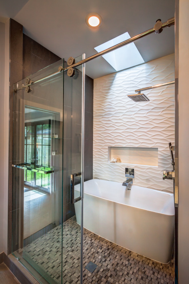 Photo of a small contemporary master bathroom in Houston with flat-panel cabinets, dark wood cabinets, a freestanding tub, a shower/bathtub combo, a one-piece toilet, multi-coloured tile, porcelain tile, grey walls, porcelain floors, a vessel sink, engineered quartz benchtops, grey floor, a sliding shower screen, white benchtops, an enclosed toilet, a double vanity and vaulted.