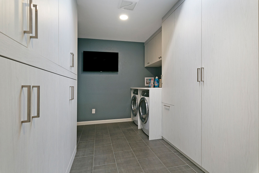 Small laundry room in San Francisco with white walls, laminate floors and grey floor.
