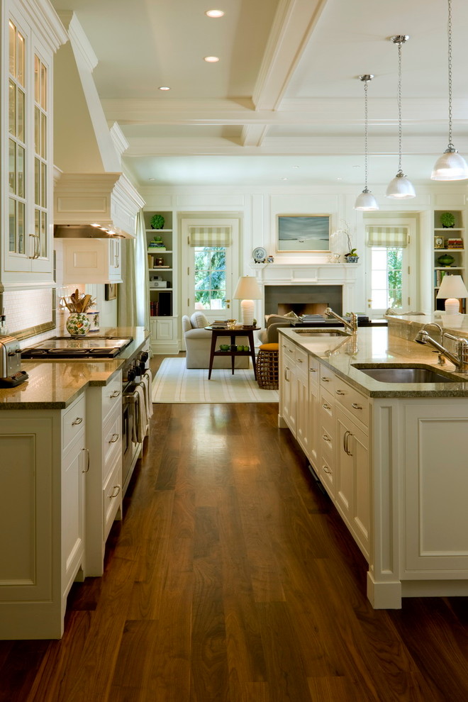 Photo of a traditional kitchen in Denver with an undermount sink, recessed-panel cabinets, white cabinets, dark hardwood floors and with island.