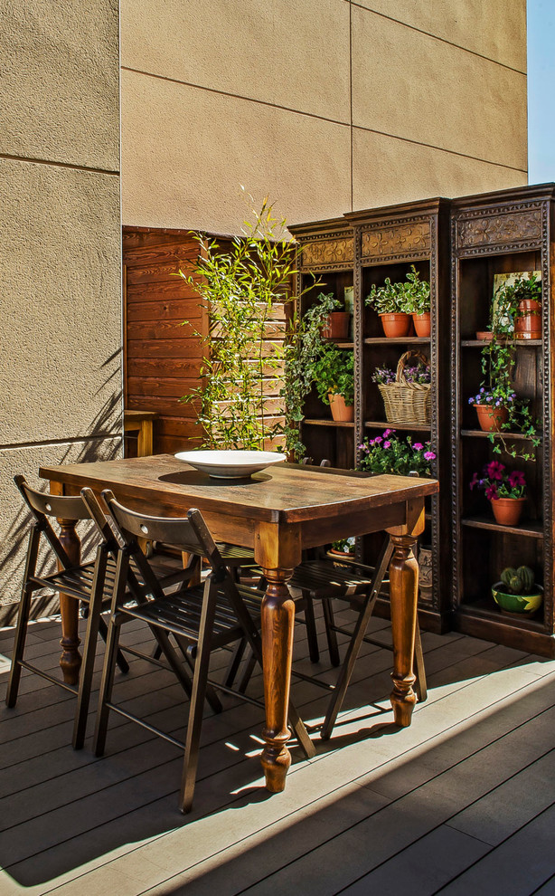Photo of a small transitional rooftop and rooftop deck in Madrid with a container garden and no cover.
