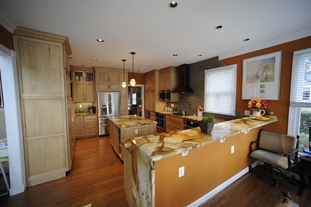 Eat-in kitchen - mid-sized transitional u-shaped light wood floor eat-in kitchen idea in Baltimore with a farmhouse sink, beaded inset cabinets, light wood cabinets, onyx countertops, stainless steel appliances and an island