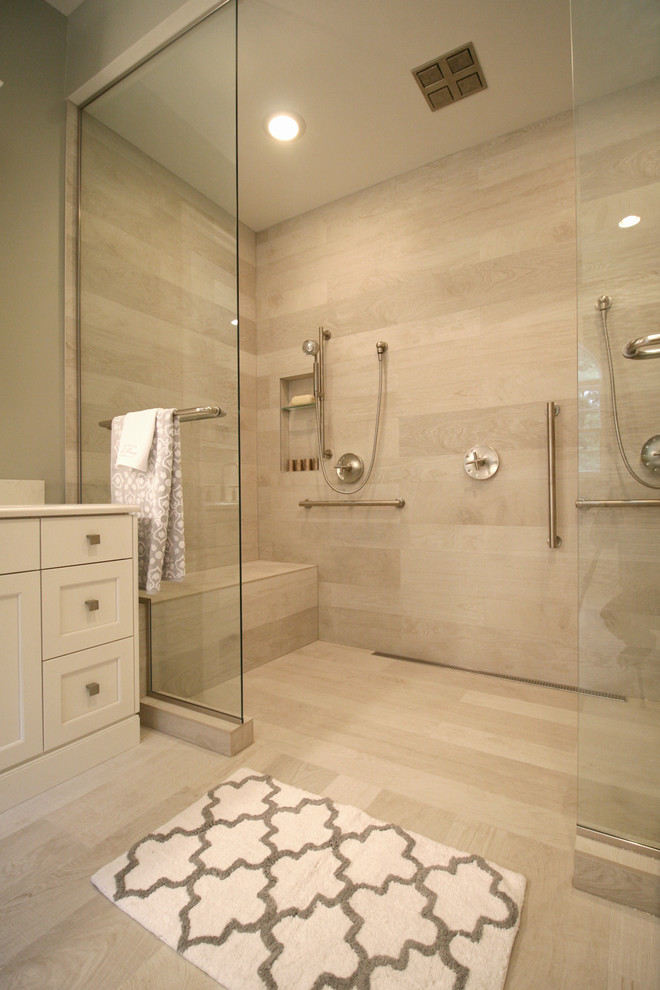 Expansive modern master bathroom in New York with an undermount sink, white cabinets, a double shower, gray tile, porcelain tile, grey walls, recessed-panel cabinets, solid surface benchtops and porcelain floors.