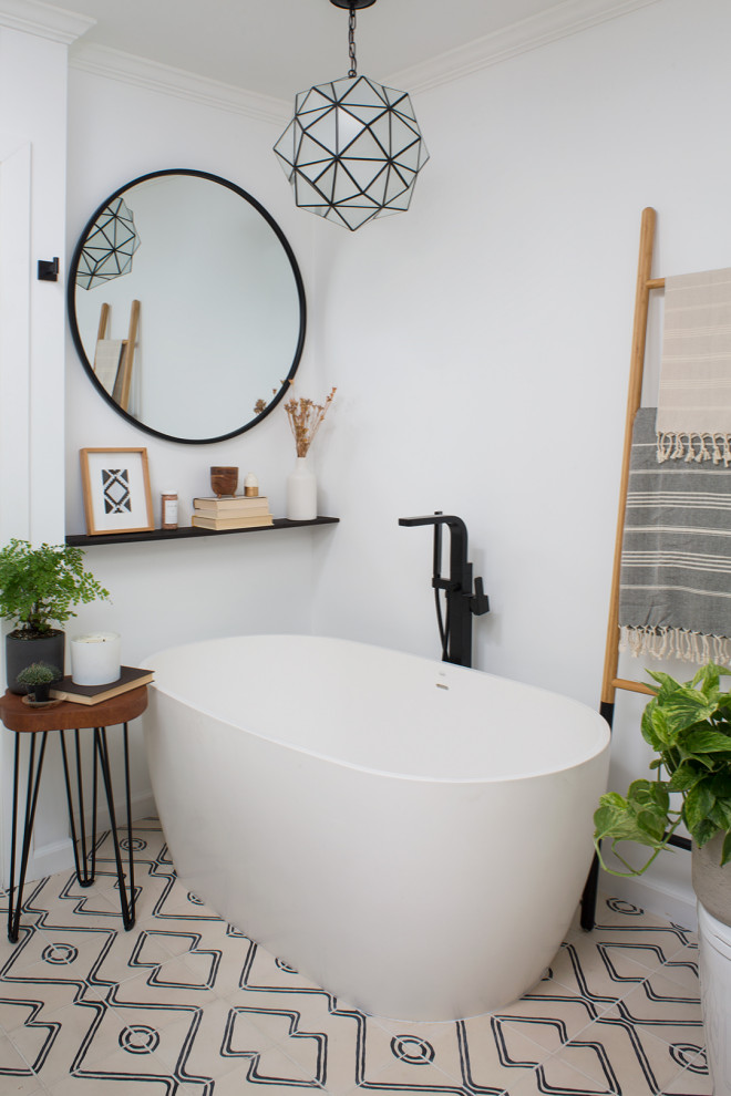 Mid-sized scandinavian master bathroom in Los Angeles with flat-panel cabinets, medium wood cabinets, a freestanding tub, an alcove shower, a one-piece toilet, white tile, marble, white walls, cement tiles, an undermount sink, granite benchtops, beige floor, a hinged shower door and black benchtops.