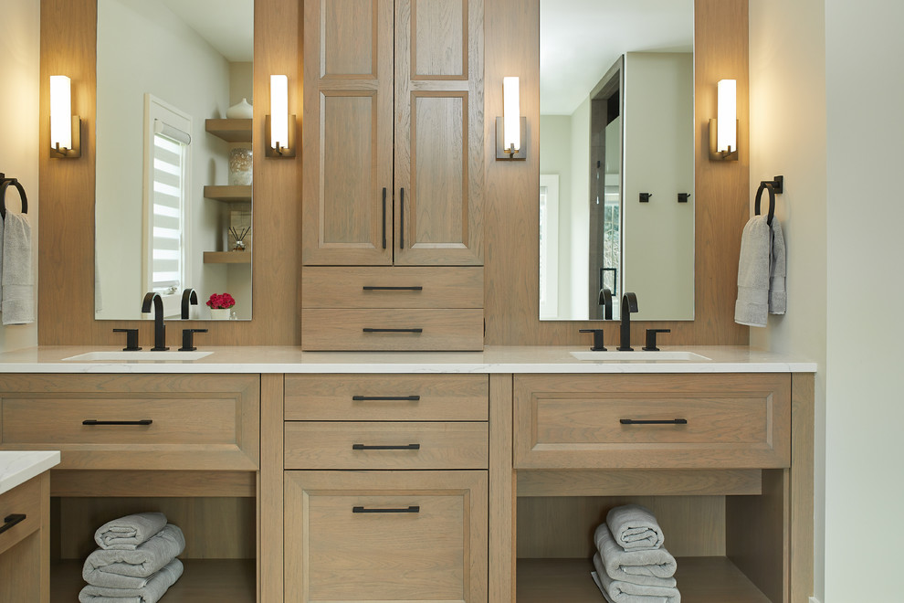 Design ideas for a large transitional master bathroom in Grand Rapids with flat-panel cabinets, light wood cabinets, white walls, an undermount sink, engineered quartz benchtops, beige floor, an alcove shower, a hinged shower door, white benchtops, a drop-in tub, laminate floors, brown tile and porcelain tile.
