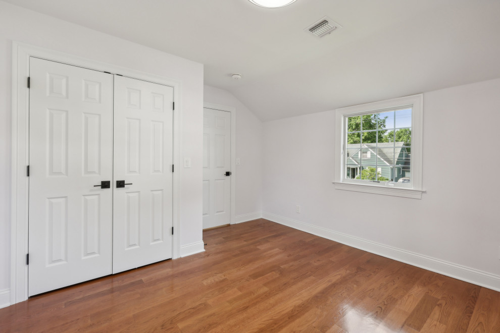 Bedroom with Sloped Ceiling and Closet Wall