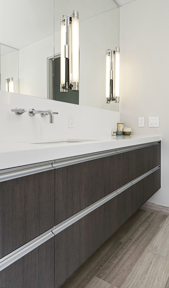 This is an example of a large contemporary master bathroom in San Francisco with flat-panel cabinets, grey cabinets, solid surface benchtops, white tile, stone slab, white walls and ceramic floors.