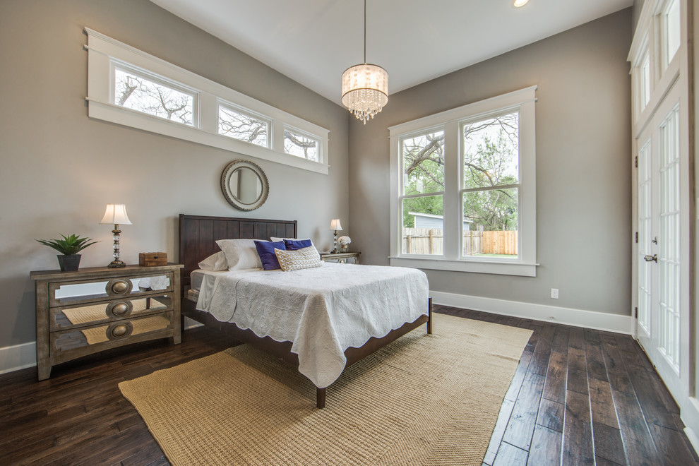 Design ideas for a mid-sized transitional master bedroom in Austin with grey walls and medium hardwood floors.