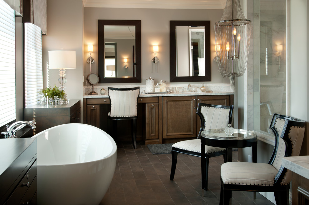 Inspiration for a large transitional master bathroom in San Diego with a freestanding tub, an undermount sink, dark wood cabinets, granite benchtops, brown tile, ceramic tile, grey walls, dark hardwood floors and raised-panel cabinets.