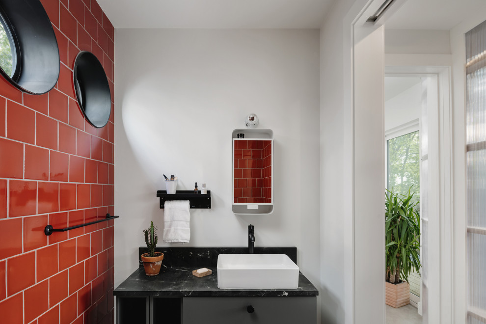 Inspiration for a small contemporary bathroom in Austin with flat-panel cabinets, grey cabinets, red tile, ceramic tile, concrete floors, black benchtops, a single vanity and a built-in vanity.