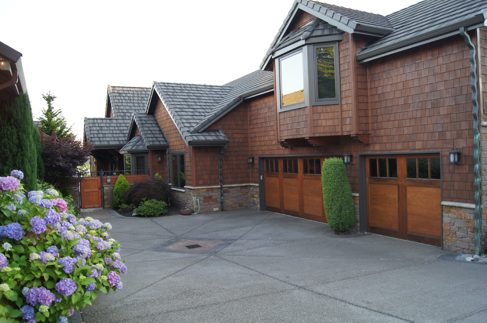 Photo of a mid-sized arts and crafts two-storey brown exterior in Portland with wood siding.