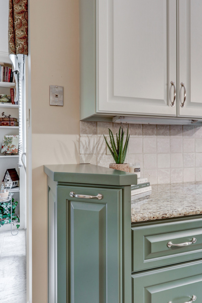Inspiration for a mid-sized transitional l-shaped ceramic tile and beige floor eat-in kitchen remodel with a double-bowl sink, raised-panel cabinets, green cabinets, granite countertops, beige backsplash, ceramic backsplash, stainless steel appliances, an island and beige countertops