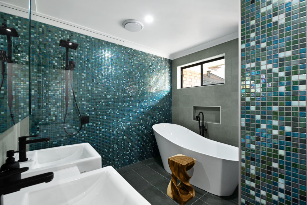 Inspiration for a contemporary master wet room bathroom in Newcastle - Maitland with a freestanding tub, blue tile, green tile, multi-coloured tile, mosaic tile, ceramic floors, grey floor, an open shower, a niche and a double vanity.