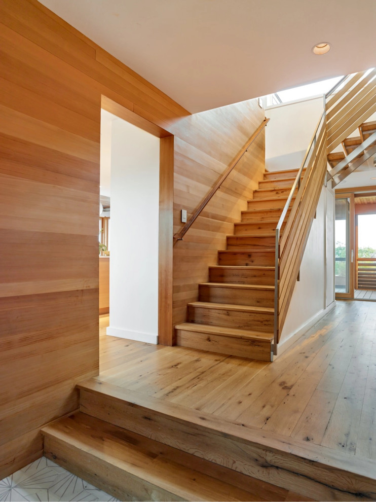 Photo of a beach style staircase in Providence with wood walls.