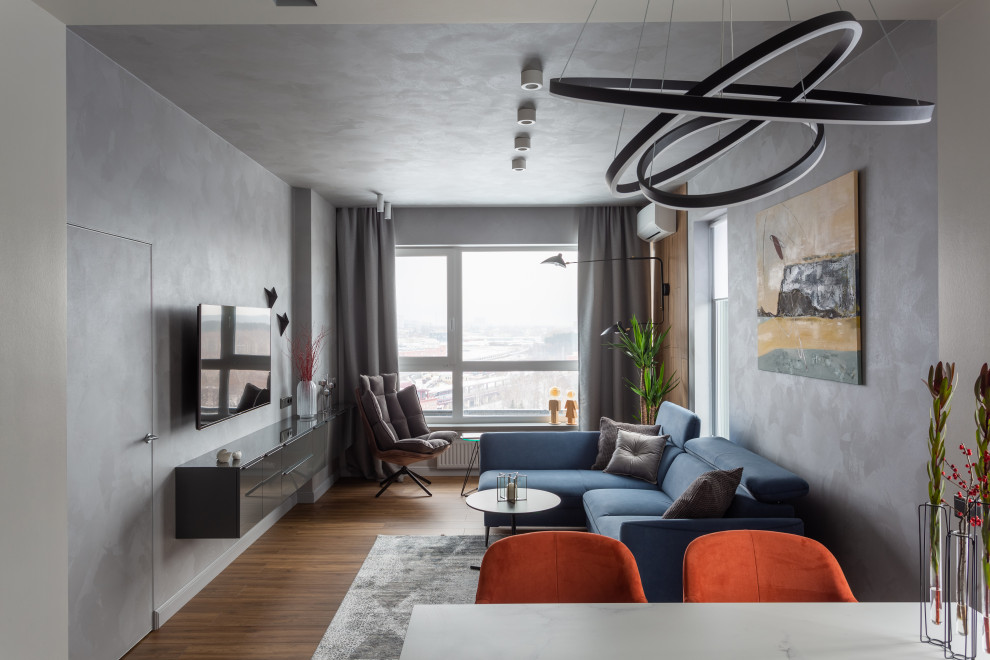 Ispirazione per un grande soggiorno contemporaneo con pareti grigie, pavimento in laminato, TV a parete e pavimento beige