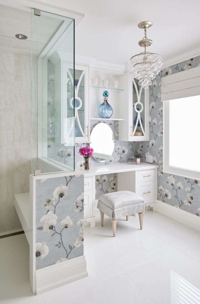 This is an example of a mid-sized traditional master bathroom in Toronto with shaker cabinets, white cabinets, a shower/bathtub combo, marble floors, engineered quartz benchtops, white floor, a hinged shower door, white benchtops and a built-in vanity.