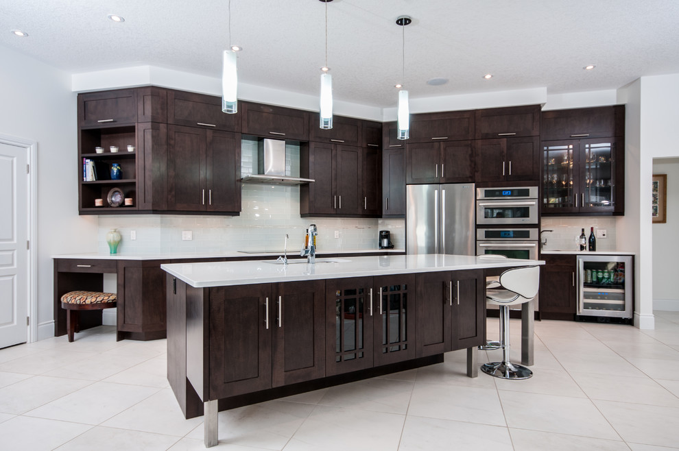 Mid-sized eclectic single-wall porcelain tile enclosed kitchen photo in Toronto with an undermount sink, shaker cabinets, dark wood cabinets, white backsplash, subway tile backsplash, stainless steel appliances, an island and solid surface countertops