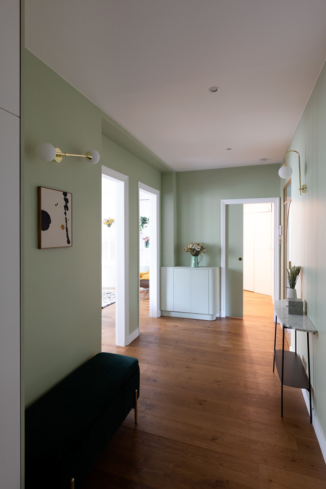 Design ideas for a large contemporary foyer in Paris with green walls, dark hardwood floors, a double front door, a metal front door and brown floor.