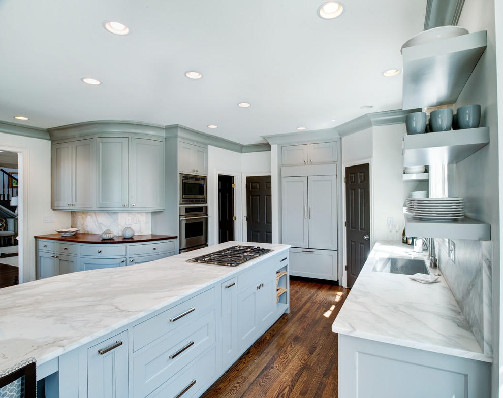 Mid-sized transitional l-shaped medium tone wood floor open concept kitchen photo in Atlanta with recessed-panel cabinets, marble countertops, white backsplash, paneled appliances and an island