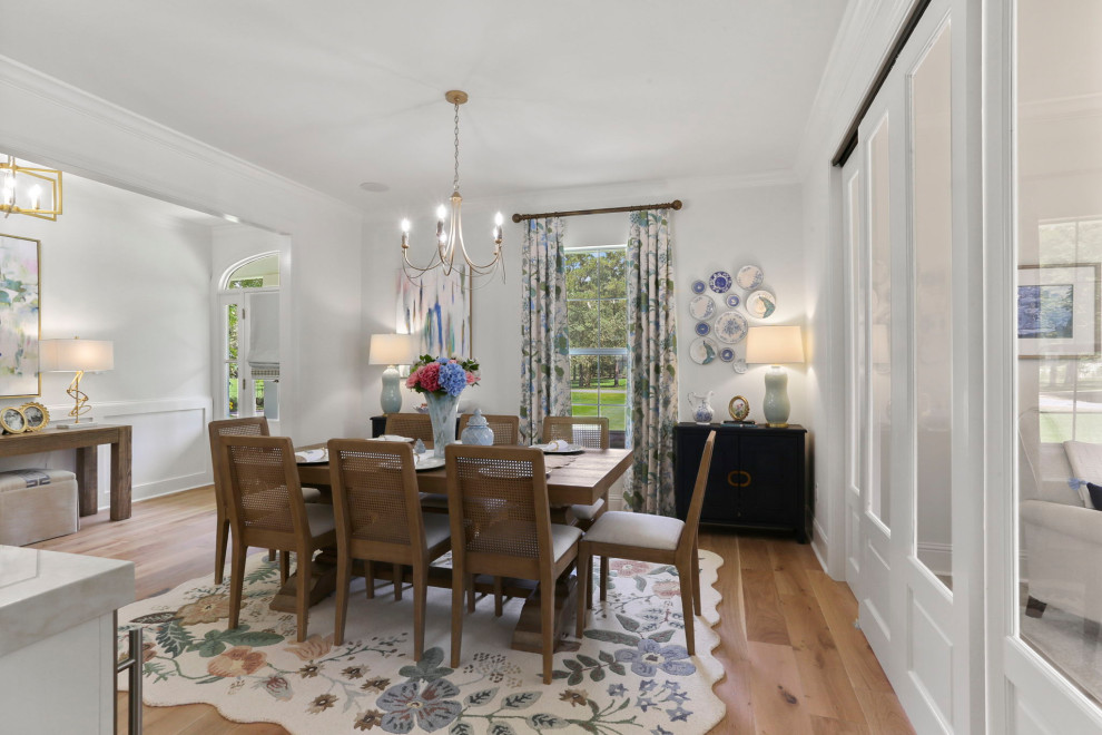Inspiration for a large transitional light wood floor and brown floor kitchen/dining room combo remodel in New Orleans with white walls