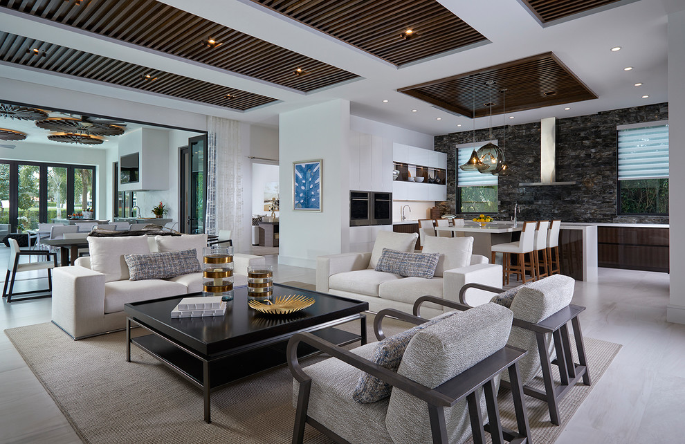 Photo of an expansive contemporary open concept living room in Miami with white walls and beige floor.