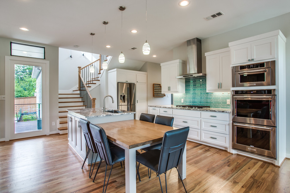 Large transitional galley eat-in kitchen in Dallas with shaker cabinets, white cabinets, blue splashback, stainless steel appliances, medium hardwood floors, with island, brown floor, an undermount sink, granite benchtops and matchstick tile splashback.