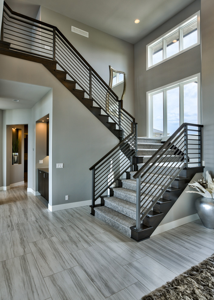 Inspiration for a contemporary wood u-shaped staircase in Omaha with wood risers.