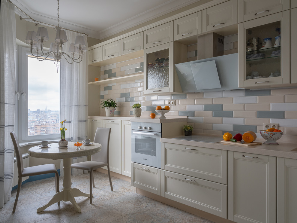 Small transitional l-shaped separate kitchen in Moscow with recessed-panel cabinets, white cabinets, solid surface benchtops, multi-coloured splashback, ceramic splashback, white appliances, porcelain floors, no island, beige benchtop and beige floor.