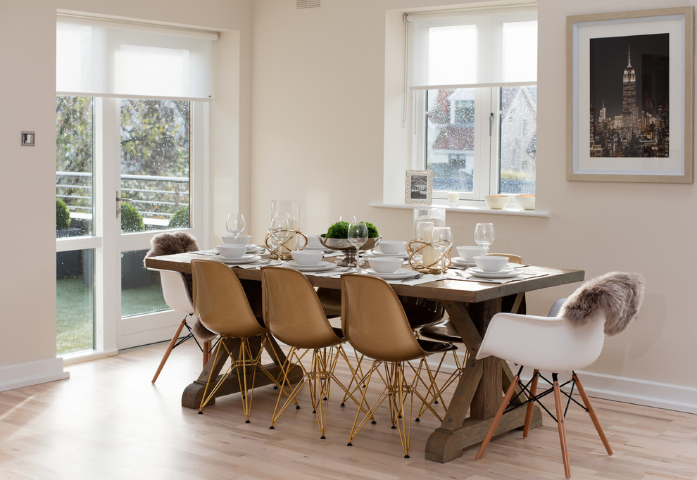 Contemporary dining room in Dublin with beige walls and light hardwood floors.