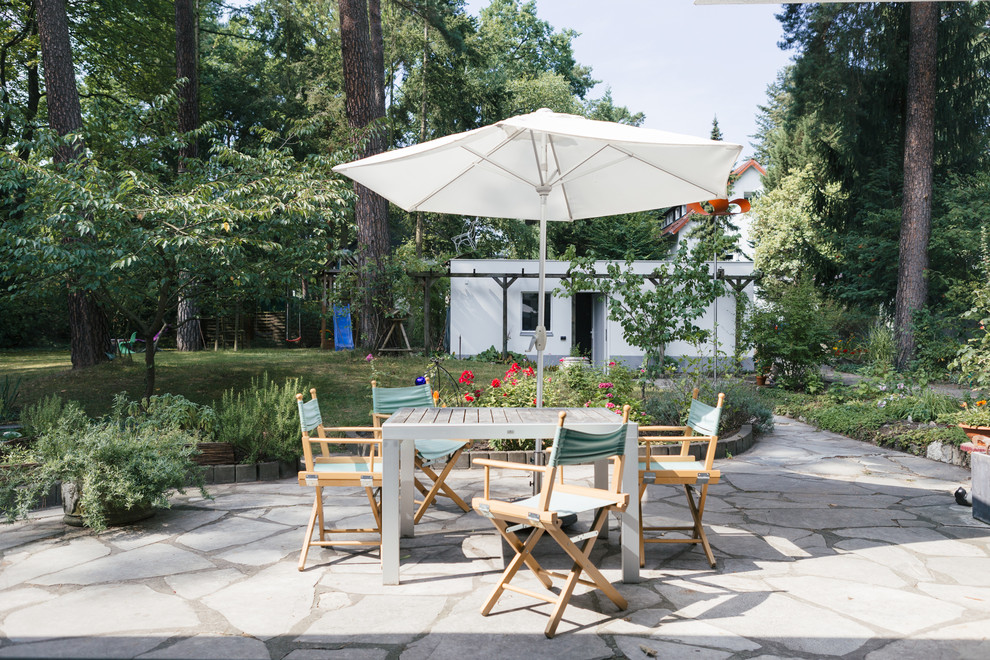 Photo of a large country backyard patio in Berlin with no cover.