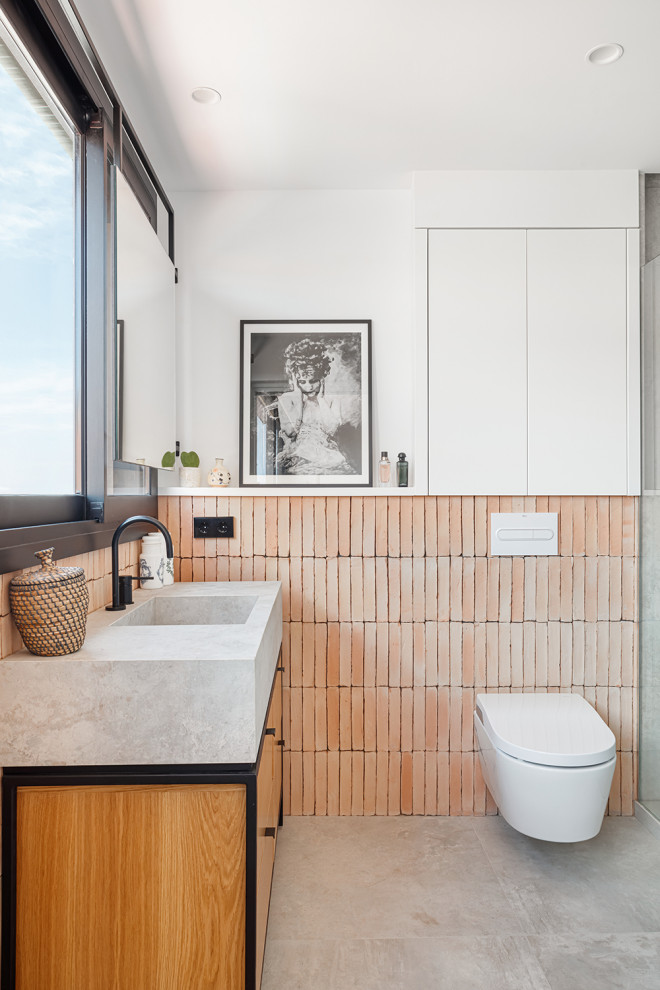 Cette photo montre une salle de bain principale et grise et rose moderne en bois brun de taille moyenne avec un placard à porte plane, une douche ouverte, WC à poser, un carrelage orange, des carreaux en terre cuite, un mur blanc, un sol en carrelage de porcelaine, un lavabo intégré, un plan de toilette en carrelage, un sol gris, un plan de toilette gris, meuble simple vasque, meuble-lavabo suspendu et un mur en parement de brique.