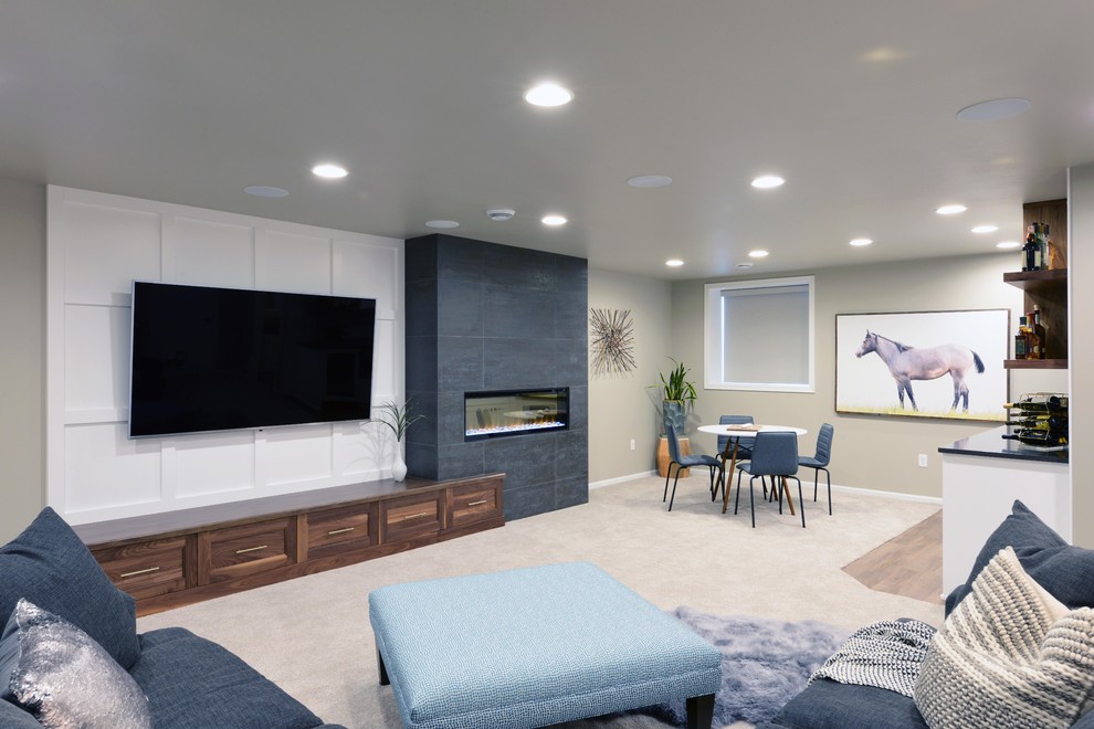 Large modern family room in Other with grey walls, carpet, a two-sided fireplace, a wood fireplace surround and beige floor.