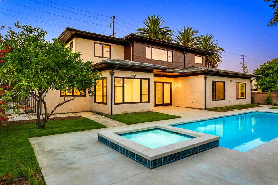 Example of a large transitional backyard concrete paver and rectangular lap hot tub design in Los Angeles