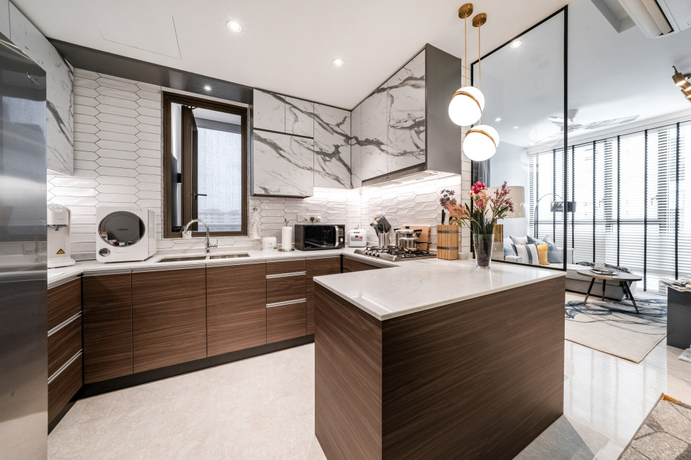 Design ideas for a contemporary u-shaped open plan kitchen in Singapore with a double-bowl sink, flat-panel cabinets, dark wood cabinets, white splashback, stainless steel appliances, a peninsula, white floor and white benchtop.