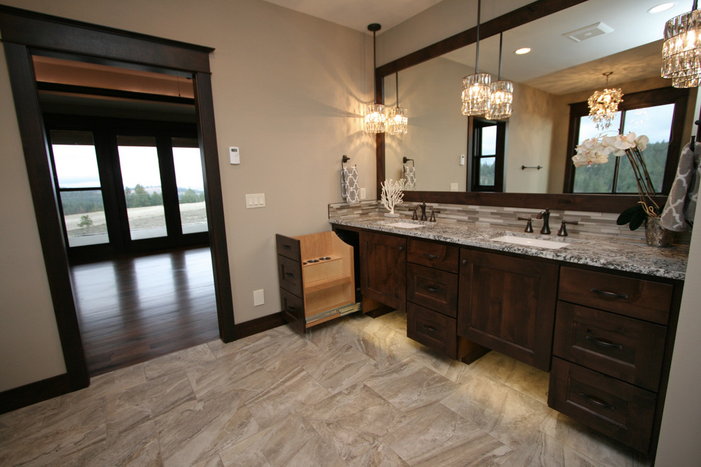 Large mountain style master beige tile and porcelain tile porcelain tile home design photo in Seattle with shaker cabinets, dark wood cabinets, a two-piece toilet, beige walls, an undermount sink and granite countertops