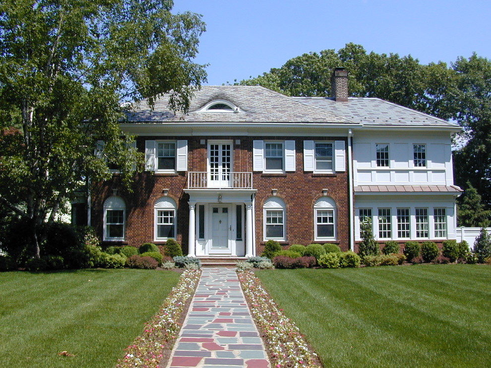 Photo of a traditional two-storey brick red exterior in New York.