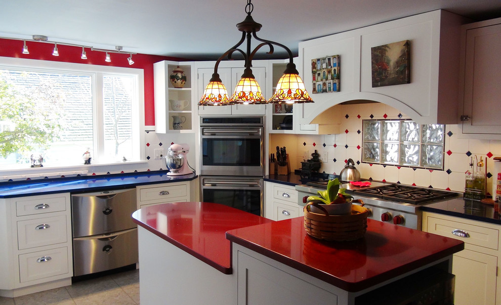Photo of a mid-sized eclectic l-shaped eat-in kitchen in Portland Maine with shaker cabinets, white cabinets, solid surface benchtops, multi-coloured splashback, ceramic splashback, stainless steel appliances, ceramic floors, with island, multi-coloured floor and blue benchtop.