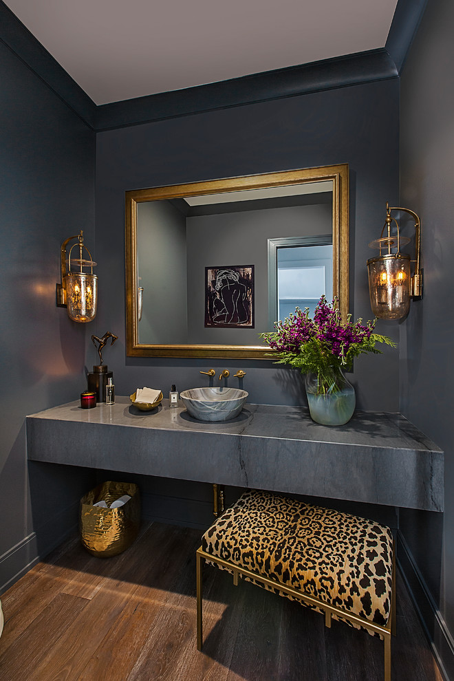 Mid-sized contemporary powder room in Detroit with grey walls, medium hardwood floors, a vessel sink, brown floor and grey benchtops.