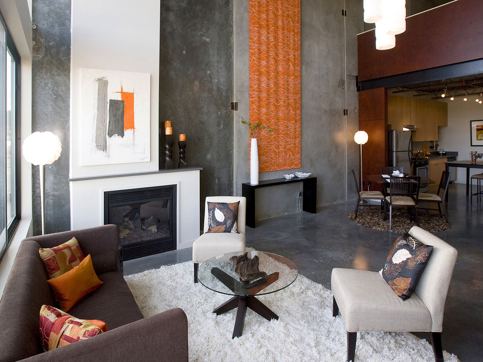 Photo of a mid-sized industrial formal enclosed living room in Portland with grey walls, concrete floors, a standard fireplace, grey floor, no tv and a metal fireplace surround.