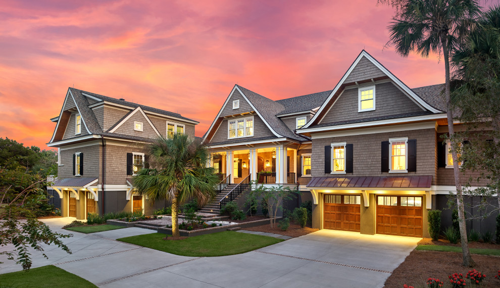Expansive transitional three-storey grey house exterior in Charleston with wood siding, a gable roof, a shingle roof, a grey roof and shingle siding.
