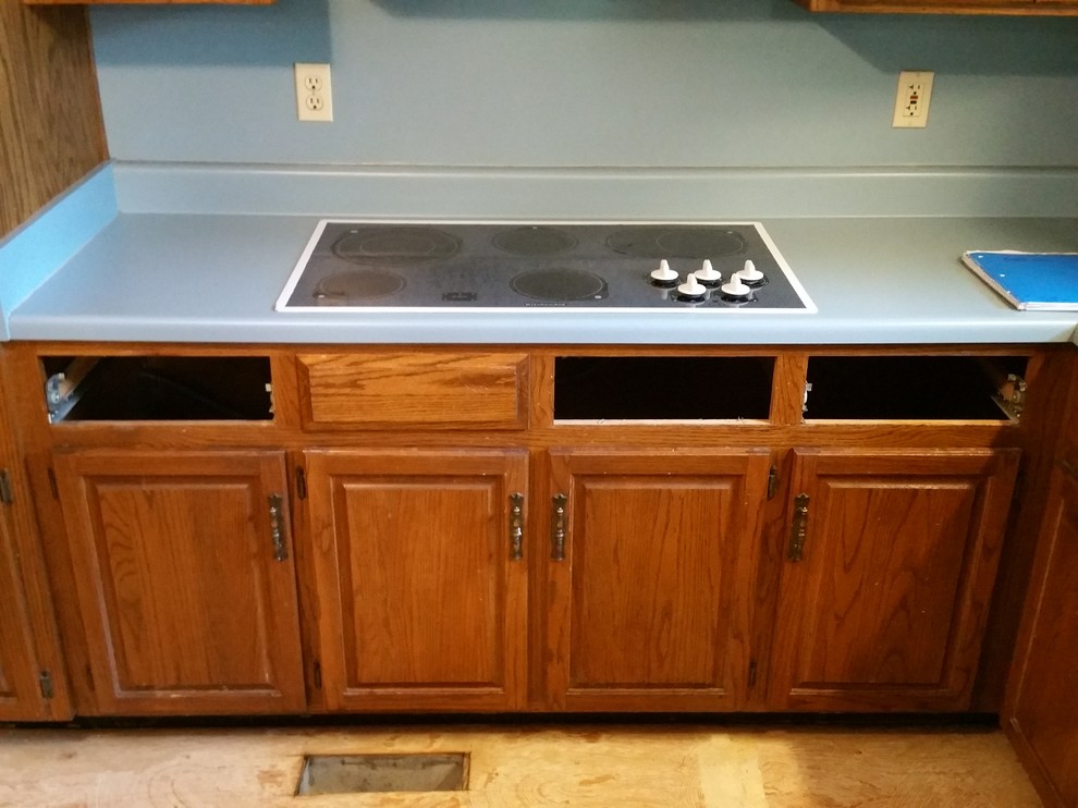 Inspiration for a small timeless l-shaped ceramic tile eat-in kitchen remodel in Birmingham with an undermount sink, raised-panel cabinets, medium tone wood cabinets, granite countertops, multicolored backsplash, mosaic tile backsplash, stainless steel appliances and an island