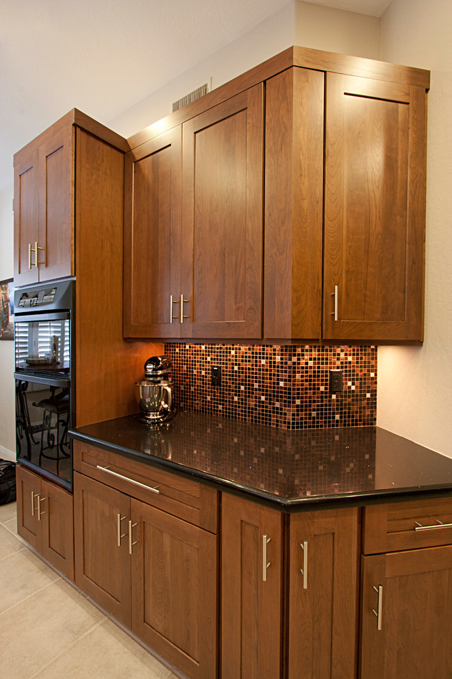 Eat-in kitchen - large transitional ceramic tile eat-in kitchen idea in Phoenix with an undermount sink, flat-panel cabinets, dark wood cabinets, quartz countertops, multicolored backsplash, mosaic tile backsplash, black appliances and no island