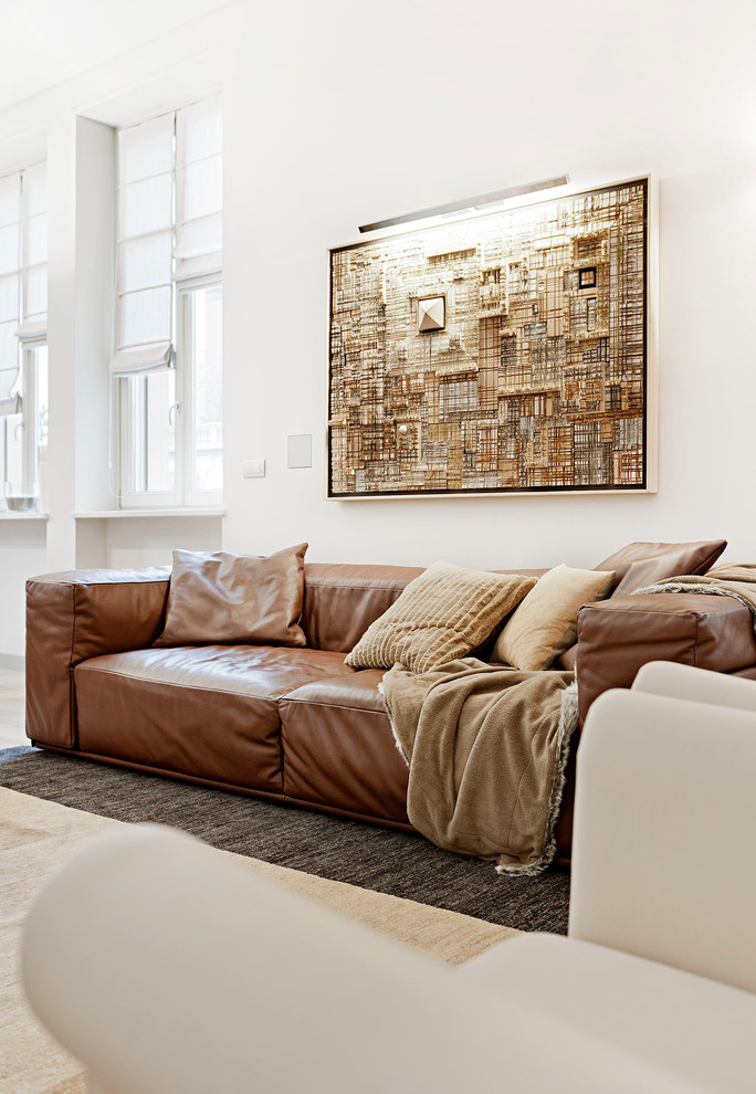 Inspiration for a mid-sized modern open concept family room in Other with white walls and light hardwood floors.