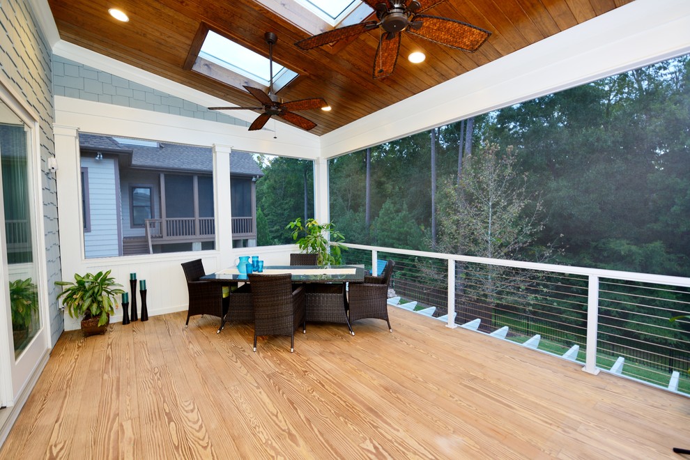 Large tropical balcony in Raleigh with a roof extension.