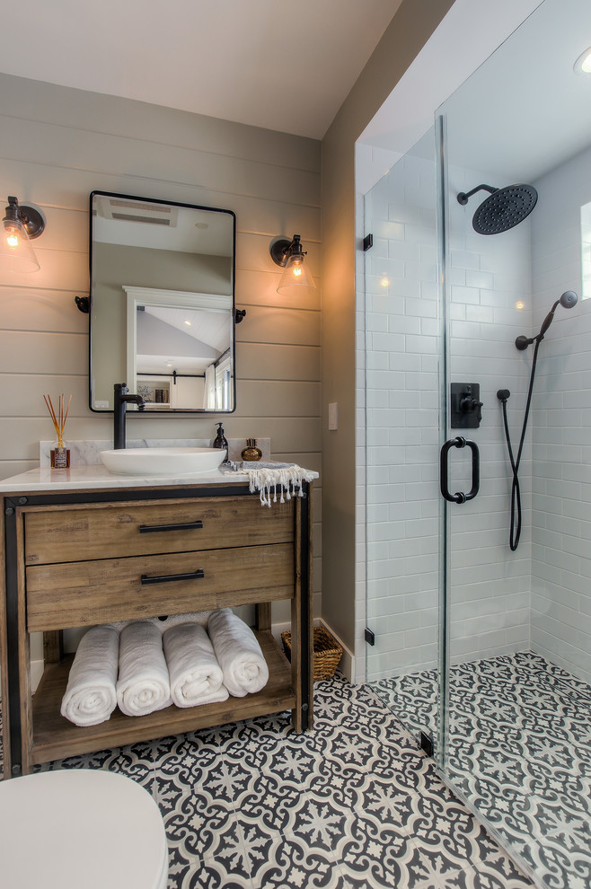 Design ideas for a transitional bathroom in Los Angeles with medium wood cabinets, a curbless shower, black and white tile, grey walls, cement tiles, a vessel sink, multi-coloured floor, a hinged shower door and flat-panel cabinets.