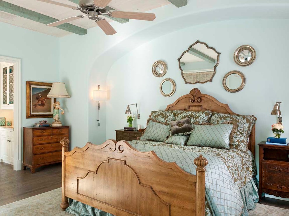 This is an example of a mediterranean bedroom in Dallas with blue walls.