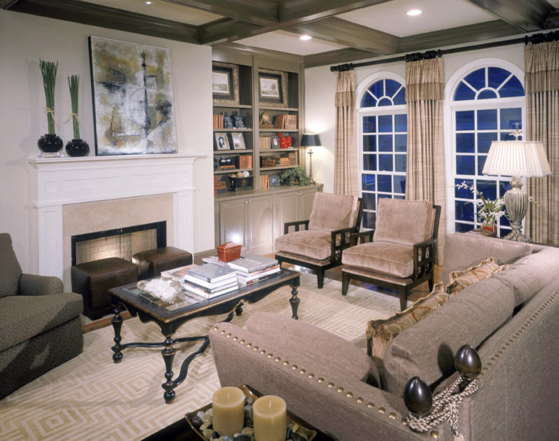 Design ideas for a large transitional open concept living room in Atlanta with white walls, a wall-mounted tv, light hardwood floors, a standard fireplace, a wood fireplace surround, brown floor and coffered.