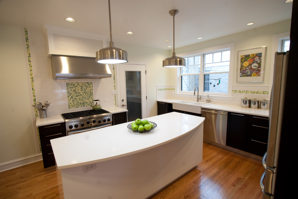 Photo of a contemporary u-shaped kitchen in Chicago with mosaic tile splashback, a farmhouse sink, flat-panel cabinets, brown cabinets, green splashback and stainless steel appliances.