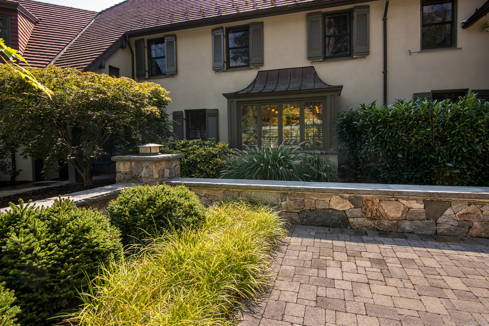 Inspiration for a large traditional front yard partial sun driveway for summer in New York with concrete pavers.